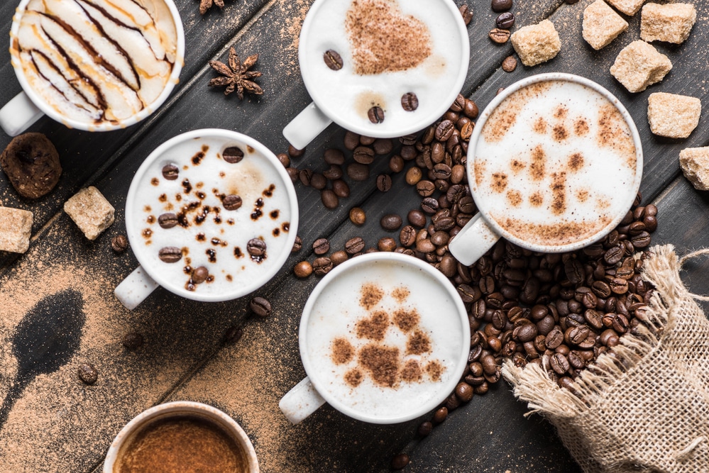 A selection of cappuccinos with different levels of foam and spices