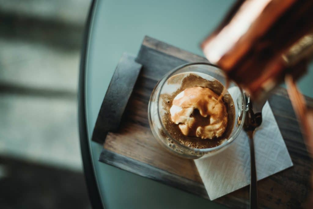 Espresso being brewed over a scoop of ice cream