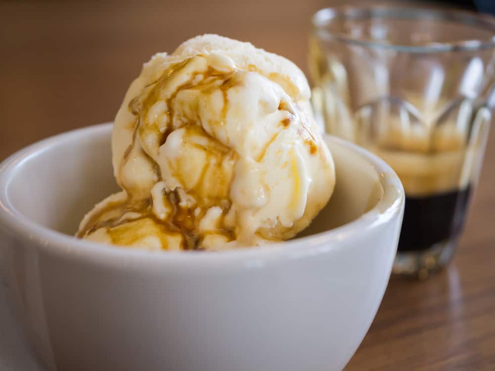 A dish with ice cream "drowned" in espresso with a shot of espresso next to it