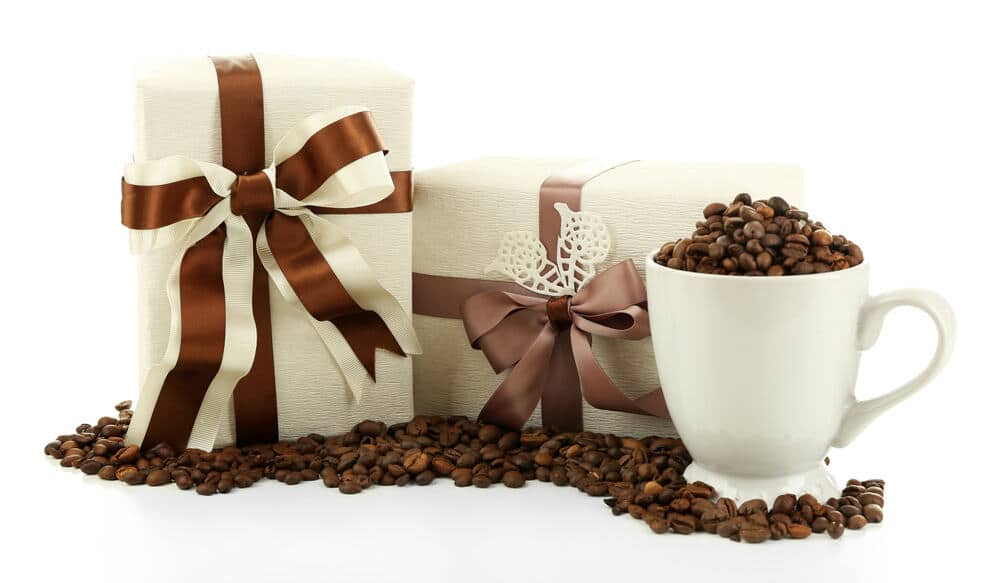 Beautiful gifts with bows and coffee grains isolated on white